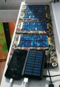 Foldable array of solar cell, portable auxiliary battery with solar cell and iPhone 5 charging